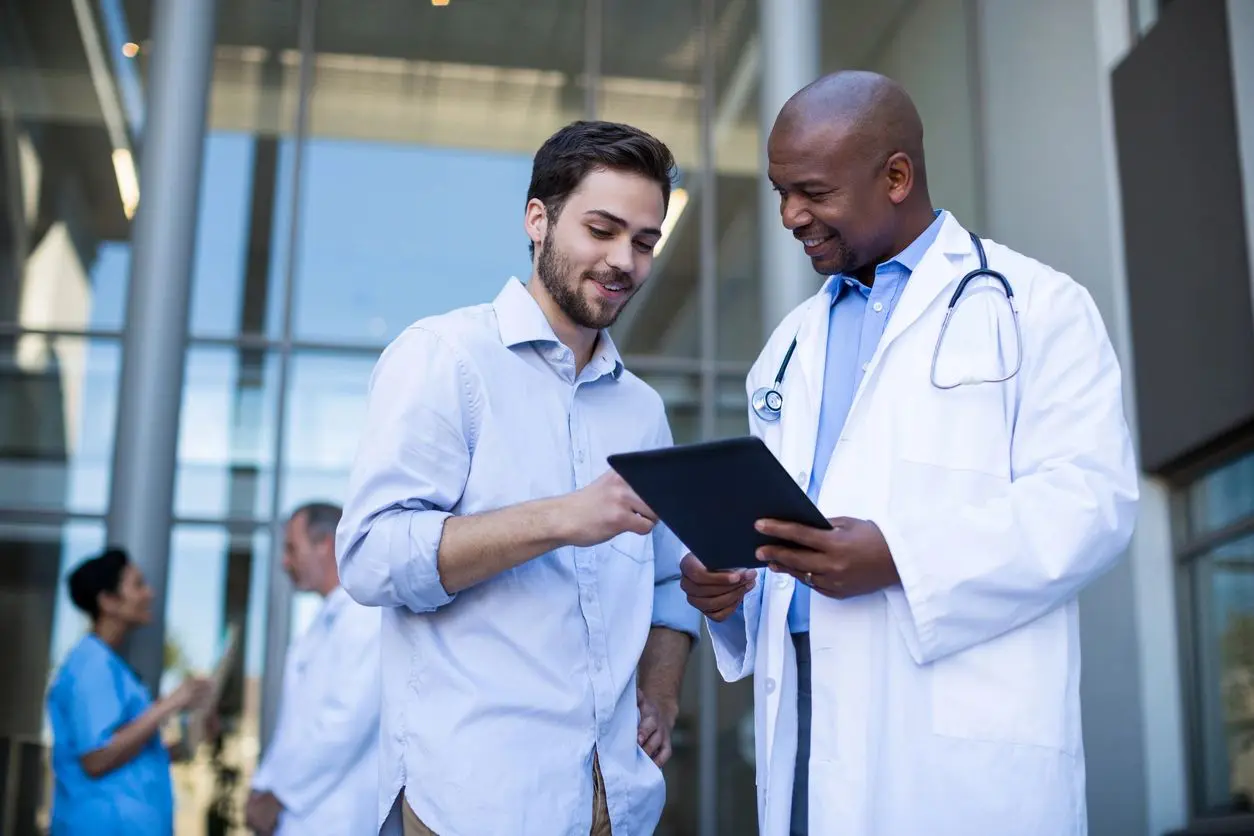 Doctor and patient discussing information on a tablet.