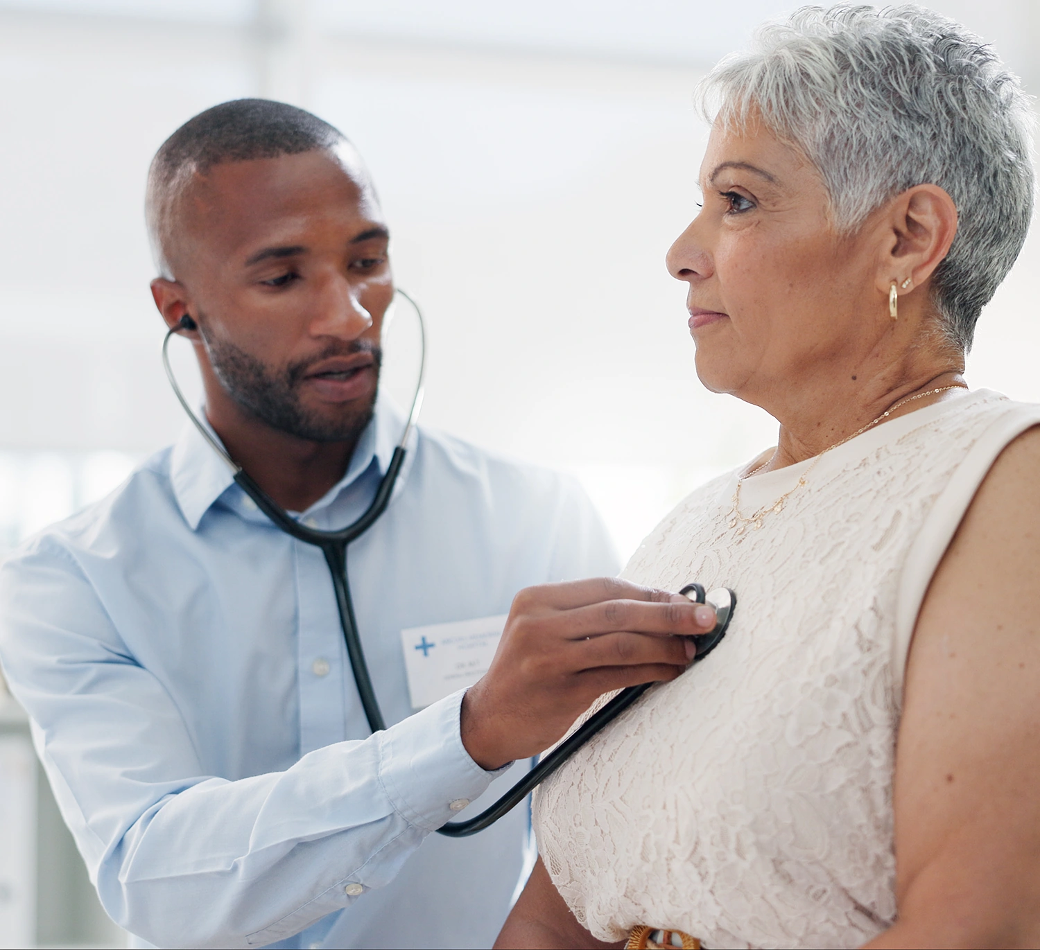 Doctor examining patient with stethoscope.